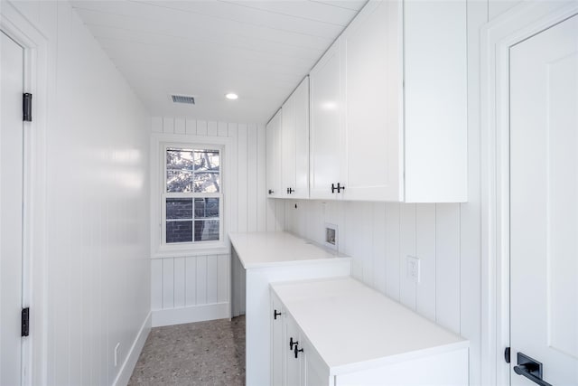 washroom featuring visible vents, baseboards, recessed lighting, hookup for a washing machine, and cabinet space