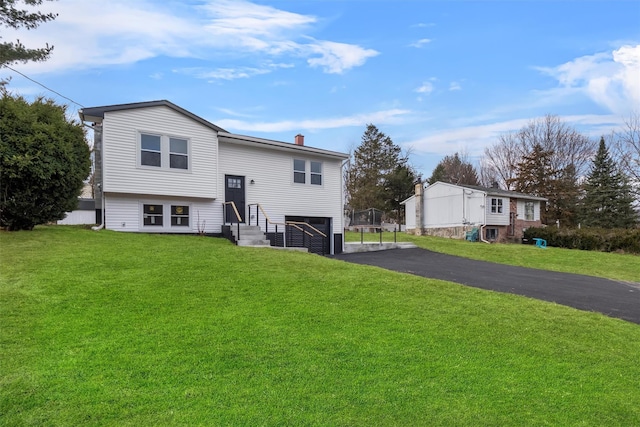 bi-level home with a front yard