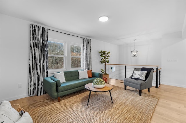 living room featuring light hardwood / wood-style floors and an inviting chandelier