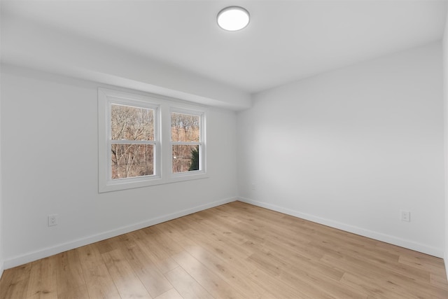 empty room with light hardwood / wood-style flooring