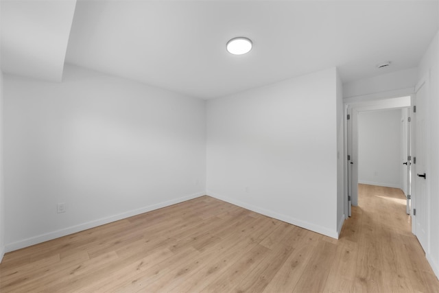 empty room with light hardwood / wood-style floors