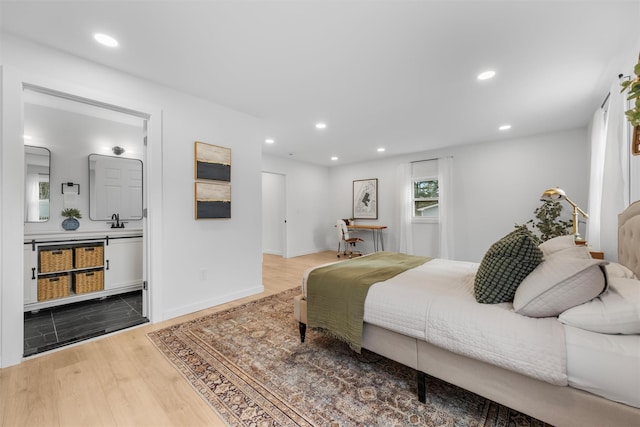 bedroom with hardwood / wood-style floors and sink