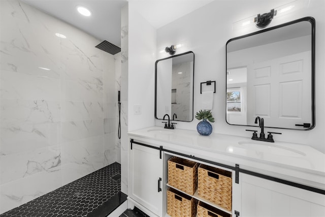 bathroom featuring a tile shower and vanity