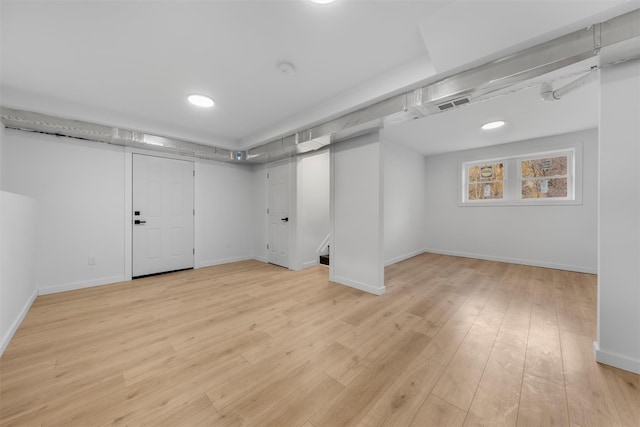 basement with light hardwood / wood-style floors