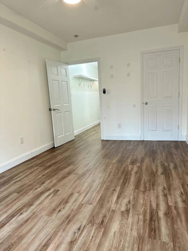 empty room featuring ceiling fan and wood-type flooring