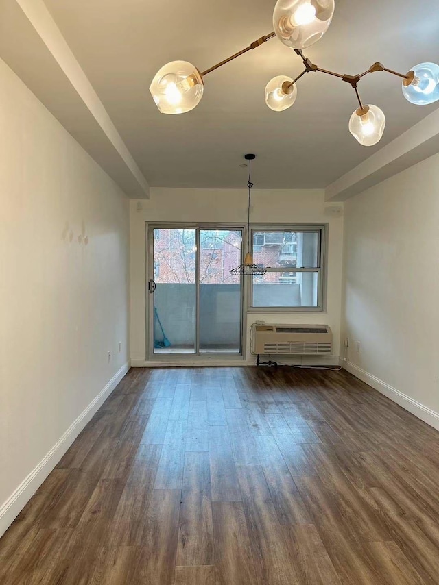 interior space with dark hardwood / wood-style floors and a wall mounted AC