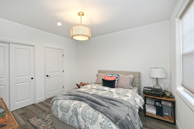 bedroom with dark wood-type flooring