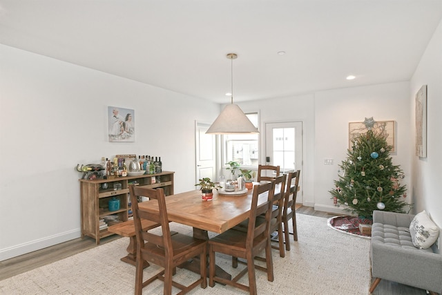 dining space featuring wood-type flooring