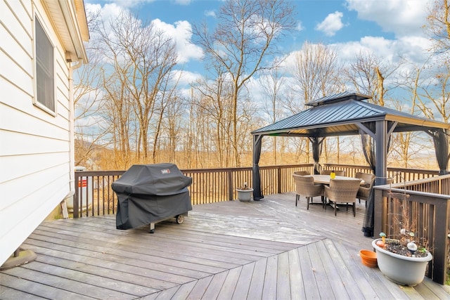 wooden deck with a gazebo and a grill