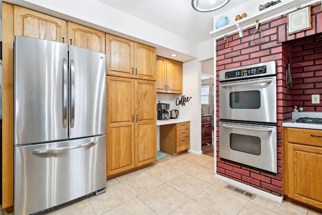 kitchen featuring light tile patterned flooring and appliances with stainless steel finishes