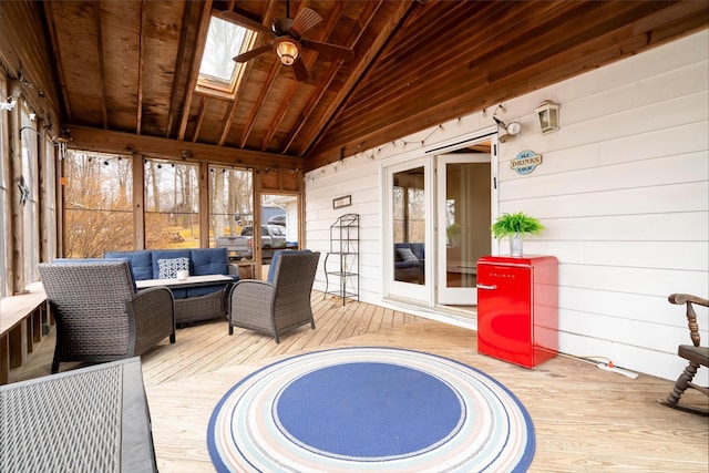 sunroom / solarium with ceiling fan, wooden ceiling, and lofted ceiling with skylight