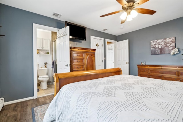 bedroom with ceiling fan, dark hardwood / wood-style flooring, and ensuite bathroom