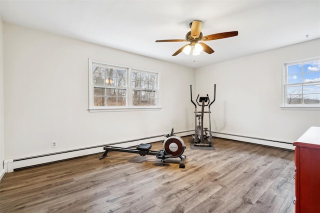 exercise room with ceiling fan, a baseboard radiator, and light hardwood / wood-style flooring