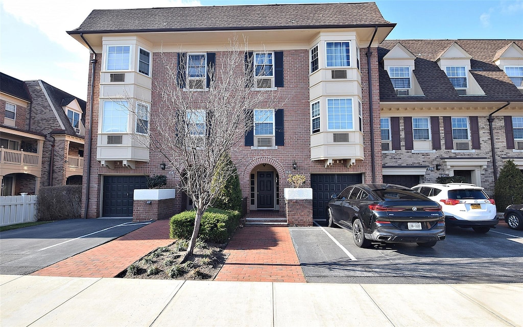 multi unit property featuring central AC and a garage