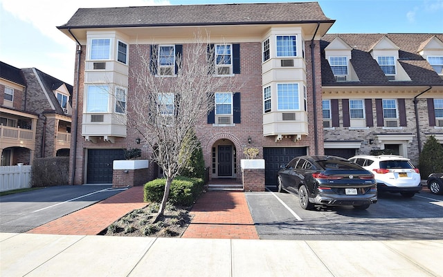 multi unit property featuring central AC and a garage