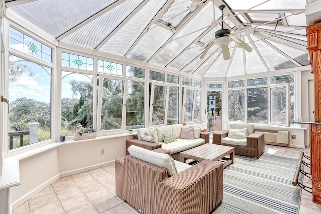 sunroom with a wall mounted AC, ceiling fan, and a healthy amount of sunlight