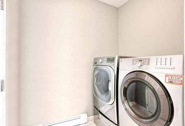 laundry room featuring washer and dryer, light tile patterned floors, and a baseboard radiator