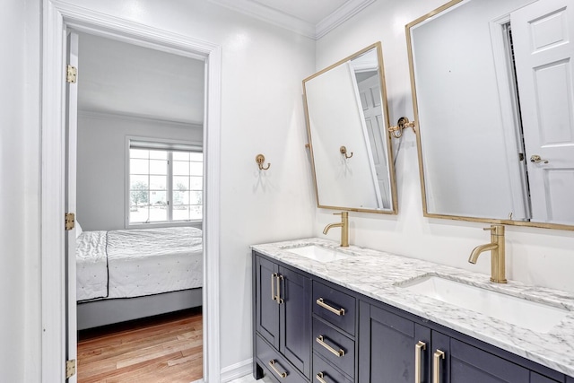 bathroom featuring hardwood / wood-style floors, vanity, and crown molding