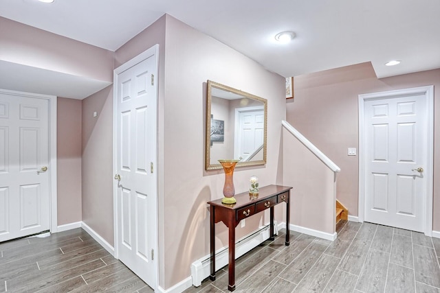 entrance foyer with a baseboard radiator and hardwood / wood-style flooring