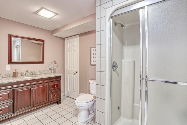 bathroom featuring tile patterned flooring, vanity, and walk in shower