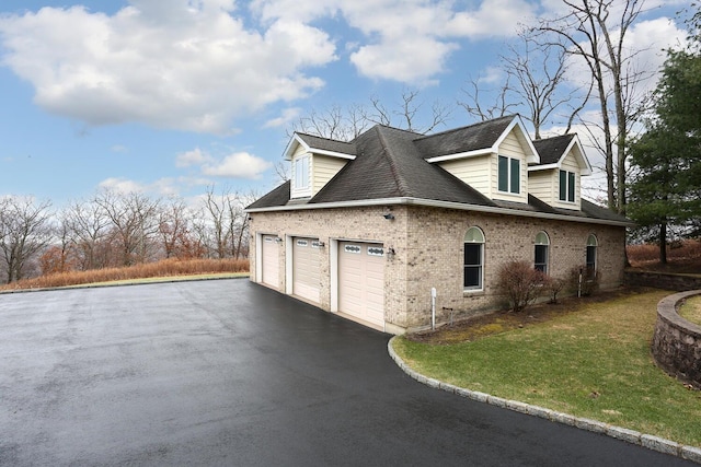 view of side of home featuring a garage