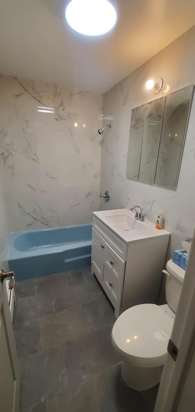 full bathroom with vanity, tiled shower / bath combo, and toilet