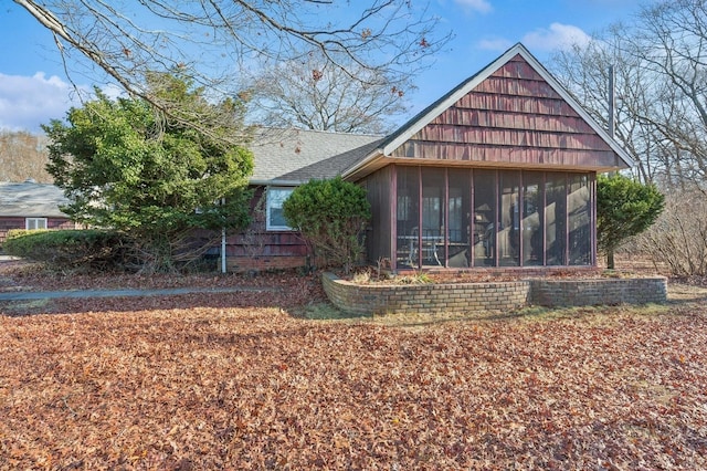 view of property exterior with a sunroom