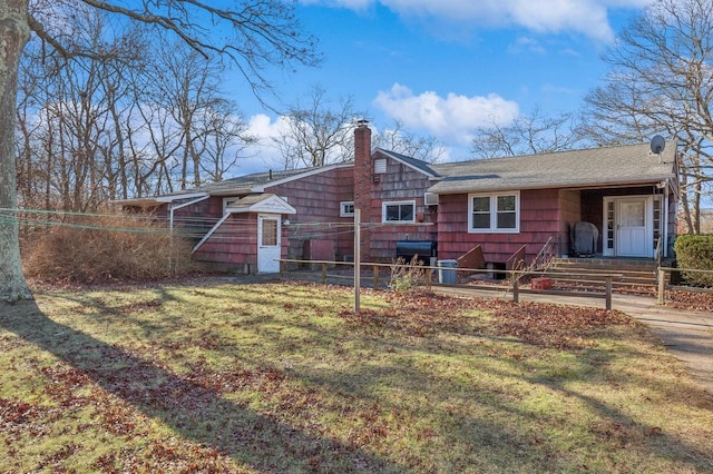 back of property featuring a lawn