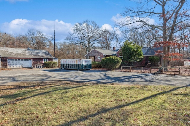 view of front of house with a front yard and a garage