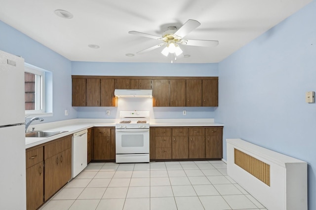 kitchen with white appliances, ceiling fan, and sink