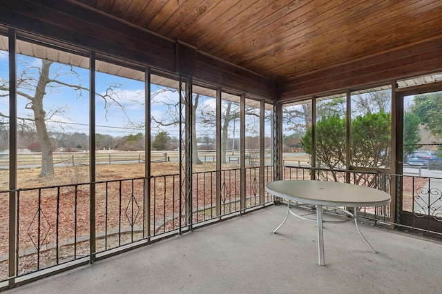 unfurnished sunroom featuring wood ceiling and a healthy amount of sunlight