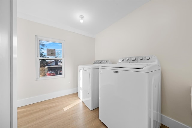 washroom with washer and clothes dryer and light hardwood / wood-style floors