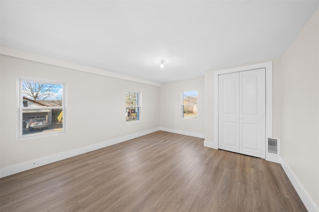 spare room with wood-type flooring