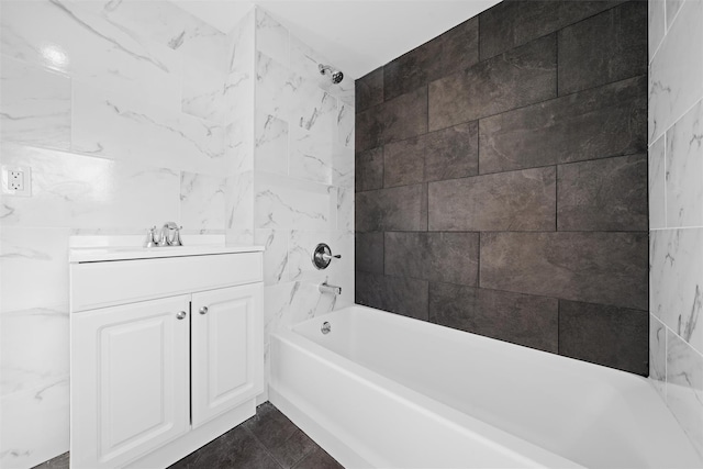 bathroom featuring vanity, tile walls, and tiled shower / bath