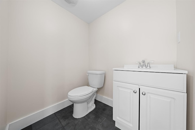 bathroom with vanity, tile patterned flooring, and toilet