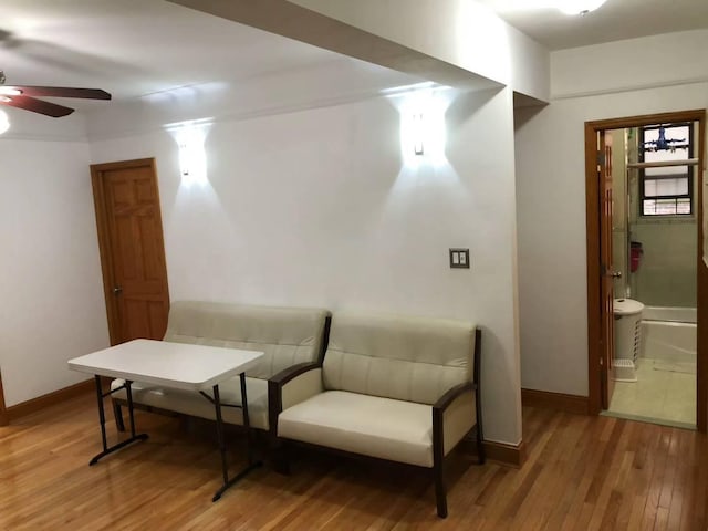 living area featuring ceiling fan and wood-type flooring