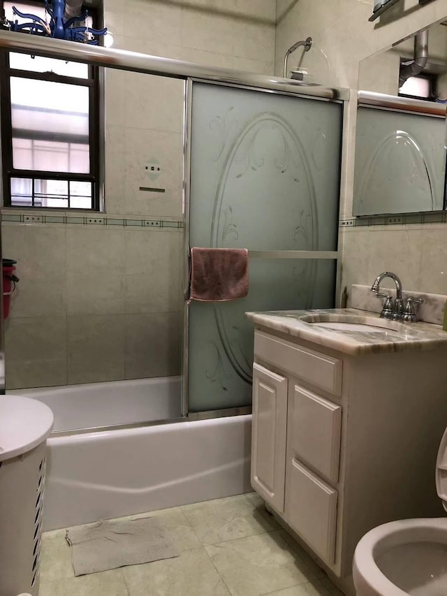 full bathroom with vanity, bath / shower combo with glass door, and toilet