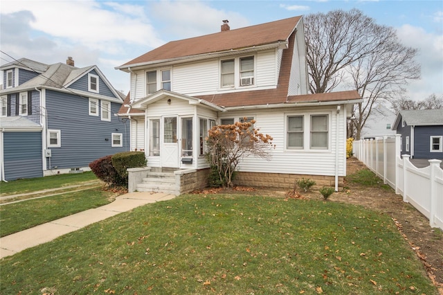 front of property featuring a sunroom and a front yard