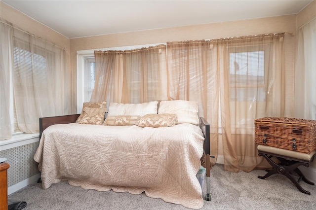 carpeted bedroom with radiator