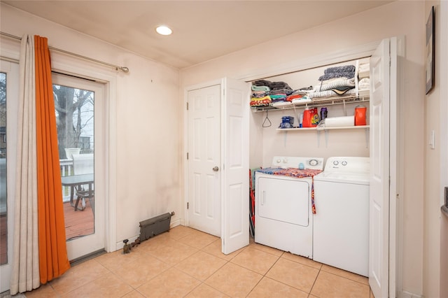 washroom featuring washing machine and dryer and light tile patterned flooring