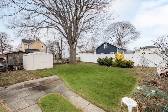 view of yard featuring a patio and a storage shed