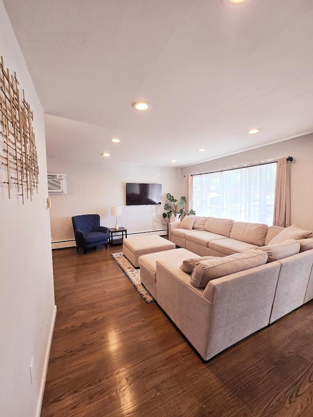 living room featuring baseboard heating, dark hardwood / wood-style flooring, and an AC wall unit