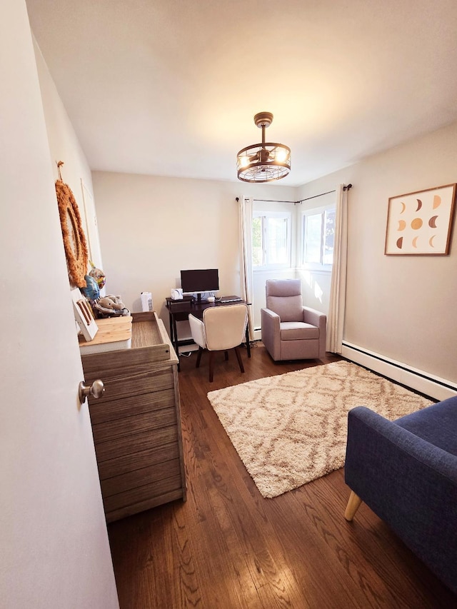 sitting room with a chandelier, dark hardwood / wood-style flooring, and a baseboard heating unit