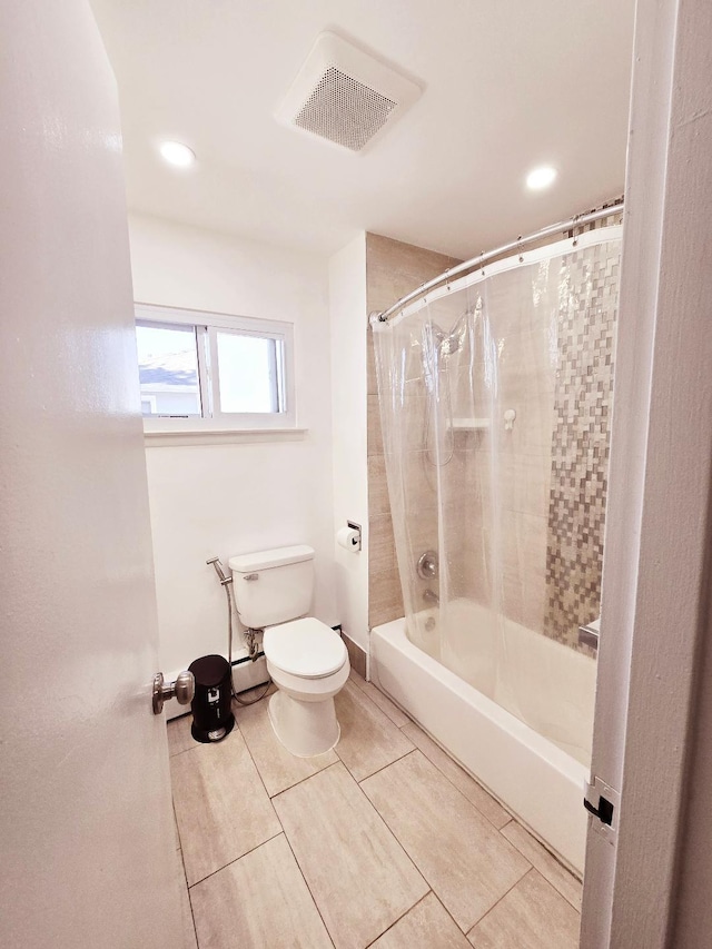 bathroom with tile patterned flooring, toilet, and shower / tub combo with curtain