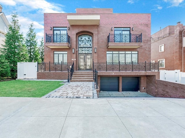 view of front of home with a front yard and a garage