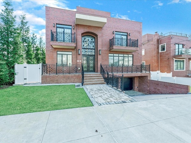 view of front facade featuring a front yard and french doors