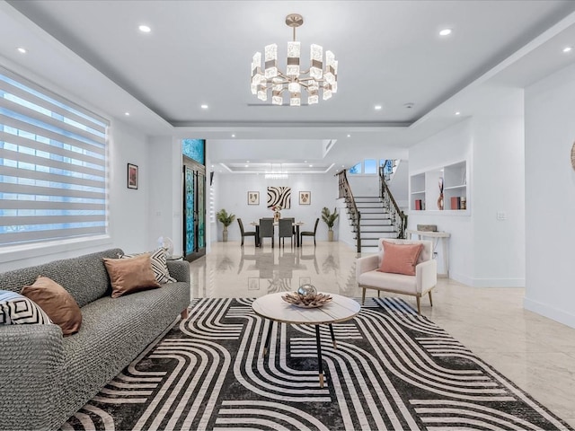 living room with a chandelier and a tray ceiling