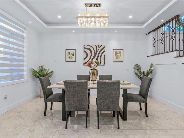 dining area featuring a raised ceiling and a notable chandelier