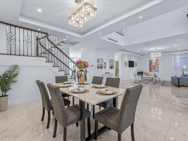 dining room with a raised ceiling and a notable chandelier