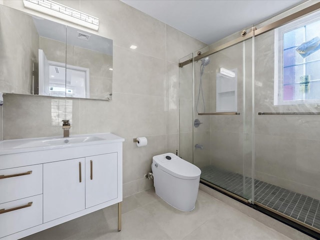 bathroom featuring vanity, toilet, an enclosed shower, and tile walls